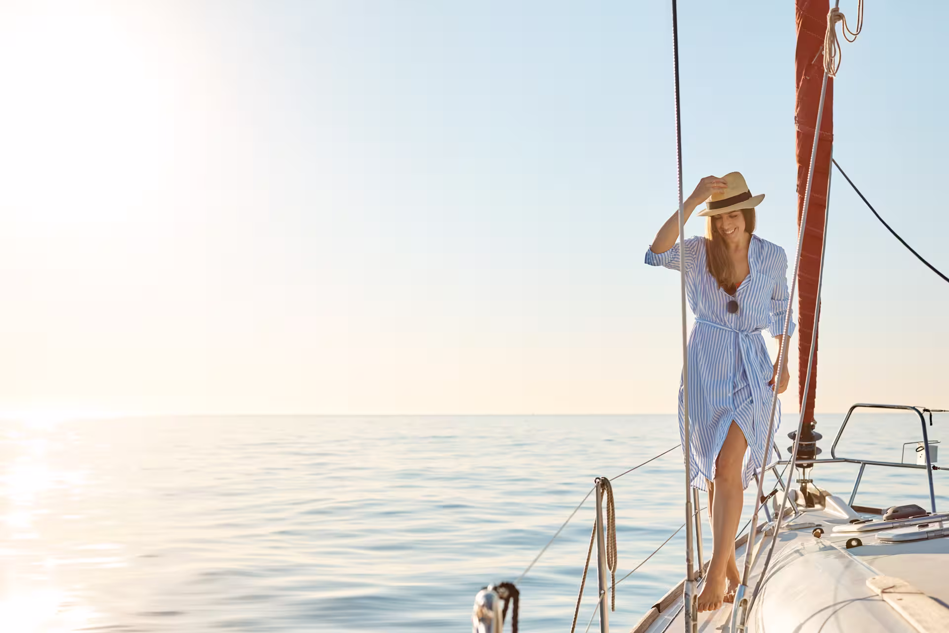 Woman enjoying a sunny 2-hour sailboat tour with ocean views, perfect for a relaxing swim and romantic getaway for two.
