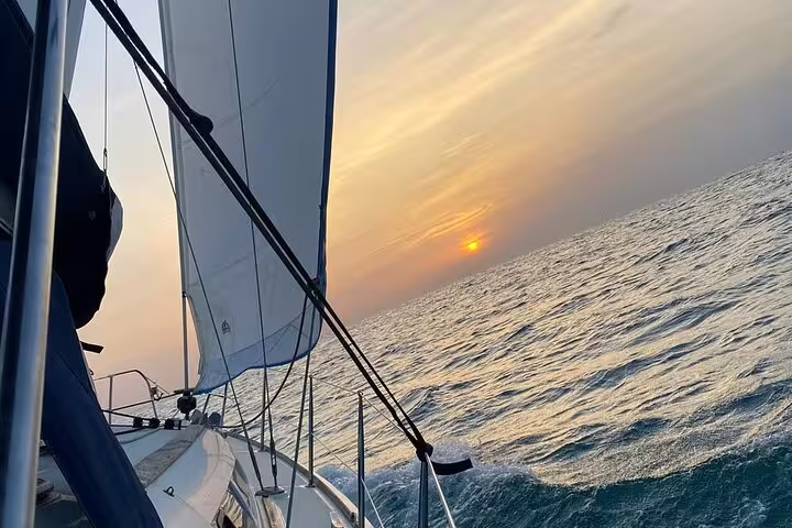 Sailing at sunset on a serene sea during a full-day trip exploring the beautiful coasts of Ibiza and Formentera.