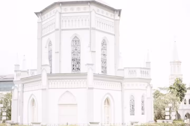 Saint Andrew's Cathedral in Singapore, an iconic Crazy Rich Asians filming location, featuring stunning white Gothic architecture.