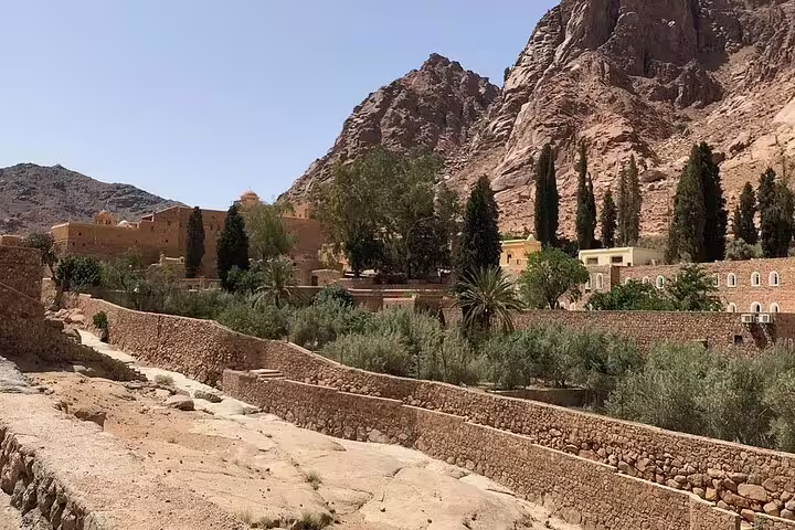 Saint Catherine’s Monastery gardens and stone walls beneath Mount Sinai, scenic stop on Dahab tour from Sharm El Sheikh