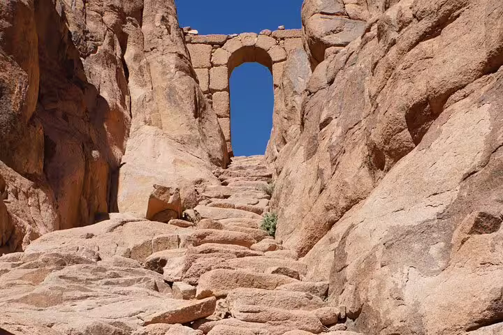 Stone steps leading to an ancient arch near Saint Catherine Monastery on Mount Sinai overnight tour from Cairo