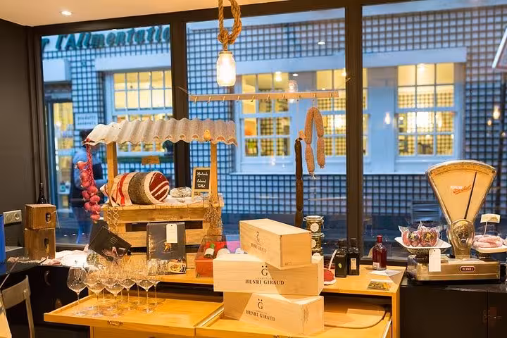 A chic French delicatessen in Saint Germain displays gourmet wines, cheeses, and charcuterie for an authentic food tour.