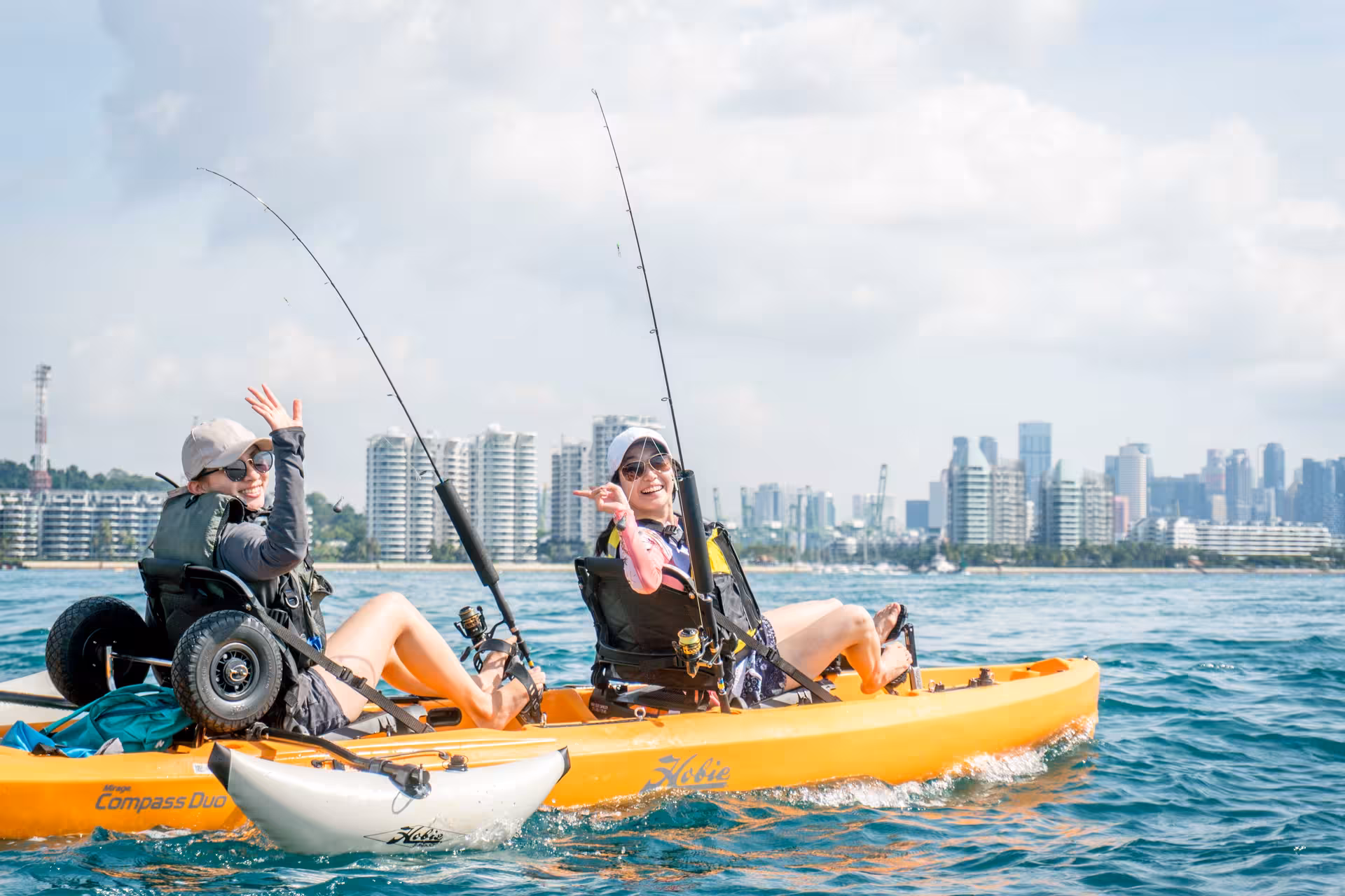 Two people kayak fishing with skyline view on Saint John Island tour.