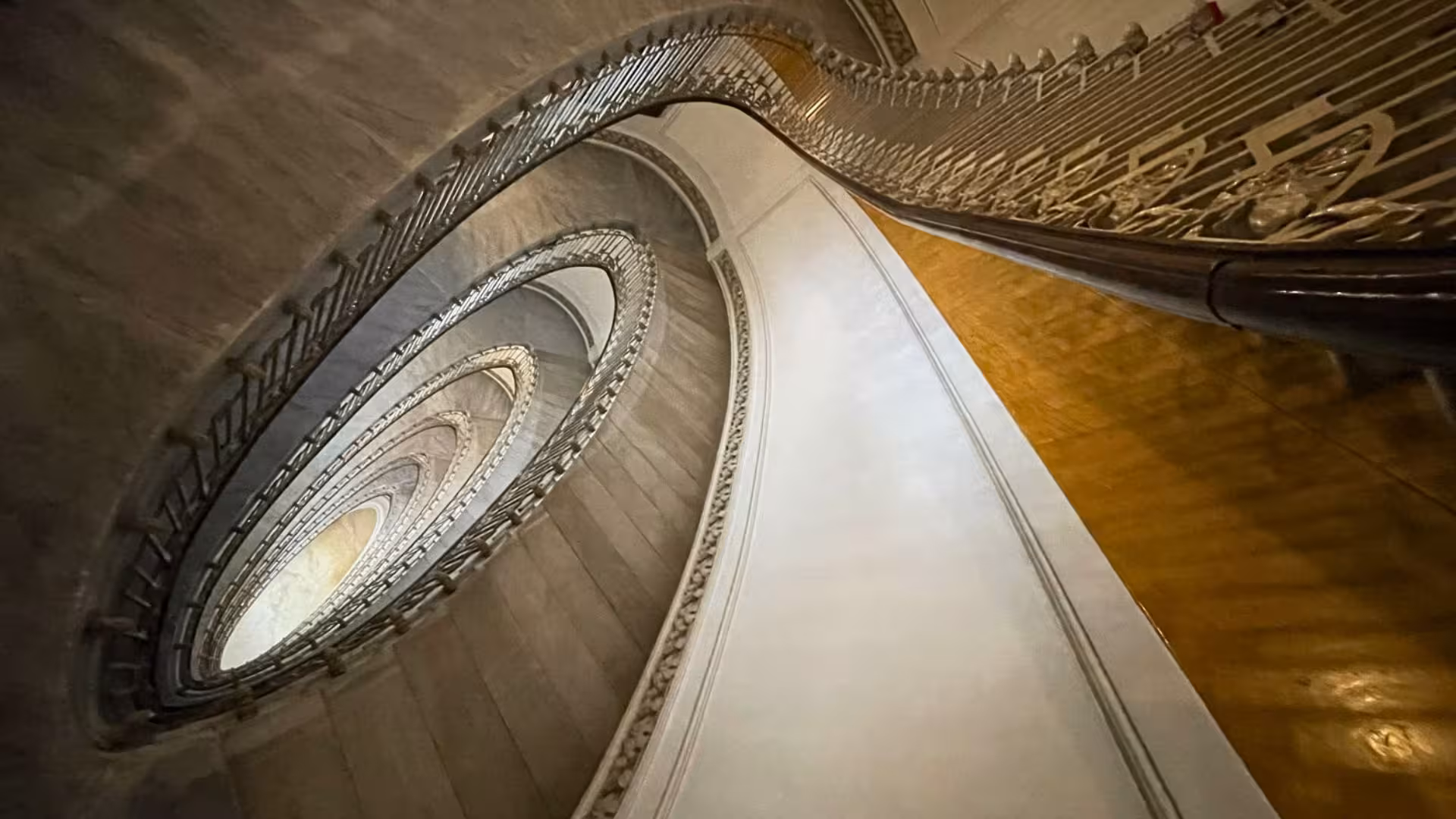 Spiral staircase inside Saint Martino Belvedere, showcasing intricate design and architectural elegance.