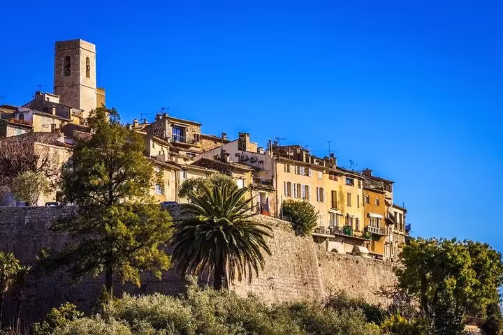 Charming medieval village of Saint-Paul-de-Vence with stone buildings and lush greenery on the French Riviera tour.