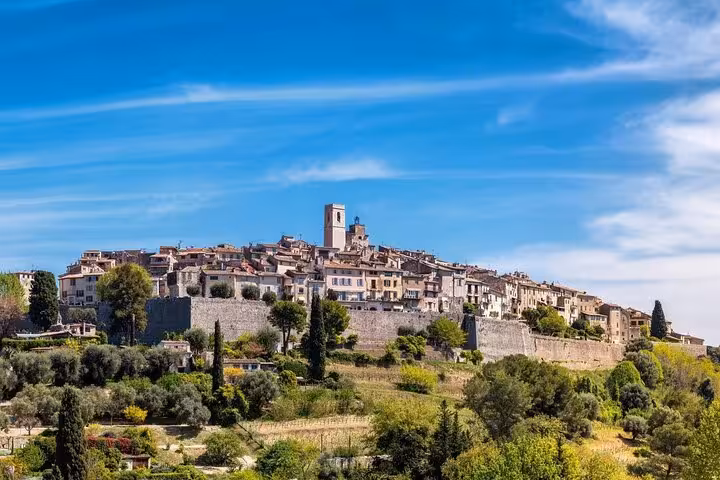 Scenic view of the historic hilltop village of Saint-Paul-de-Vence under clear blue skies on a Riviera tour.