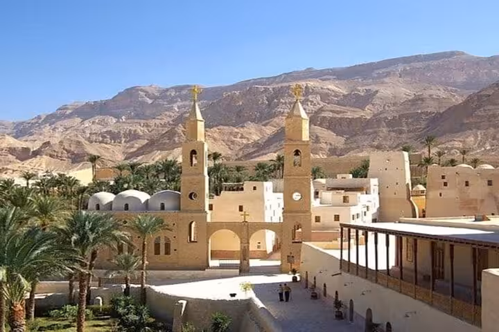 Panoramic Saint Paul Monastery near Hurghada with twin bell towers, palm trees and Red Sea desert backdrop