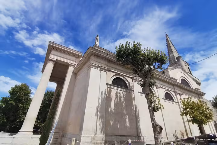 Saint-Rémy-de-Provence church and bell tower under blue sky, Provence culture and landscapes tour