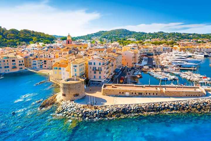 Aerial view of Saint-Tropez's vibrant marina and historic buildings, ideal for a private full day tour experience.