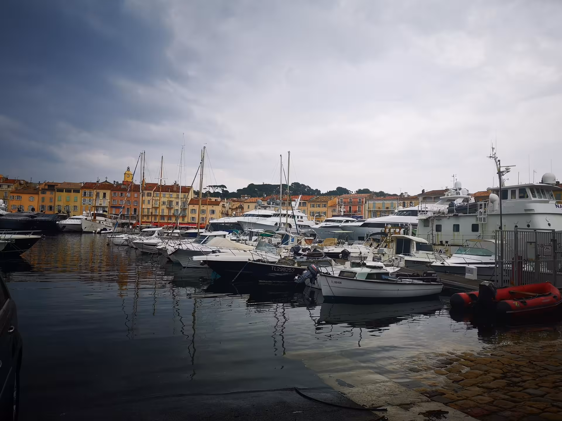 Boats and yachts in Saint-Tropez harbor with colorful waterfront, French Riviera private day trip from Hyeres