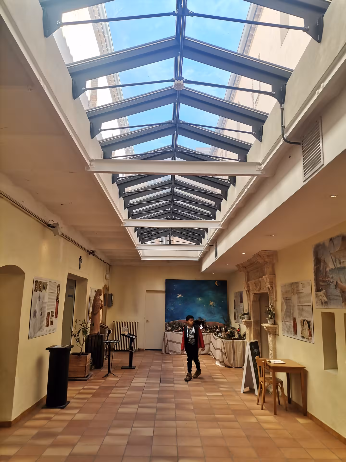 Skylit corridor at Sainte-Baume sanctuary museum, indoor visit on the sacred hike to Grotte Sainte-Madeleine