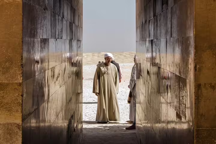 Travelers at ancient stone gateway on Sakkara, Memphis and Dahshur private guided tour with lunch and pickup