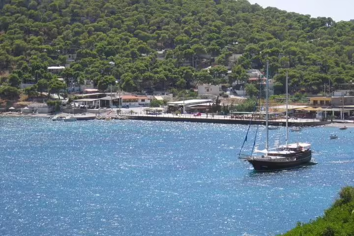 Sailboat anchored in a sparkling bay on Salamina Island during a full-day private tour with coastal views