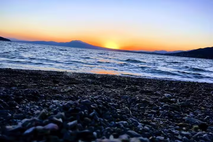 Sunset over the Saronic Gulf from Salamina Island beach, scenic highlight of a full-day private tour