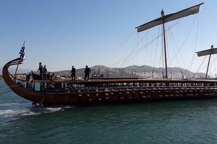 Traditional wooden boat sailing near Salamina Island on a full-day private tour from Athens, Greece