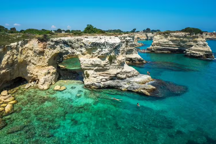 Turquoise coves and dramatic limestone cliffs of the Adriatic coast in Salento, a highlight of the Enchanting Puglia tour
