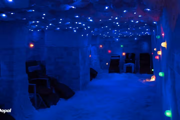 Blue-lit salt cave room with lounge chairs, part of Sharm El Sheikh salt therapy and local shopping tour