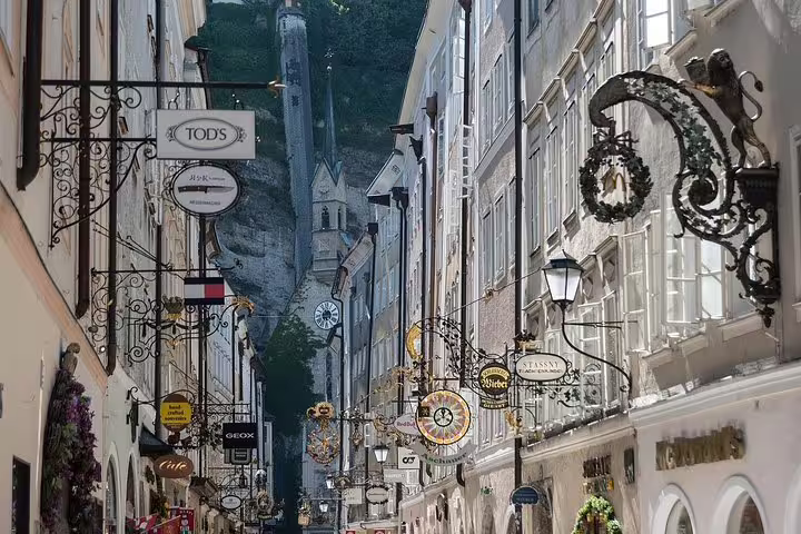 Salzburg Getreidegasse old town street with ornate shop signs on a private day trip from Vienna