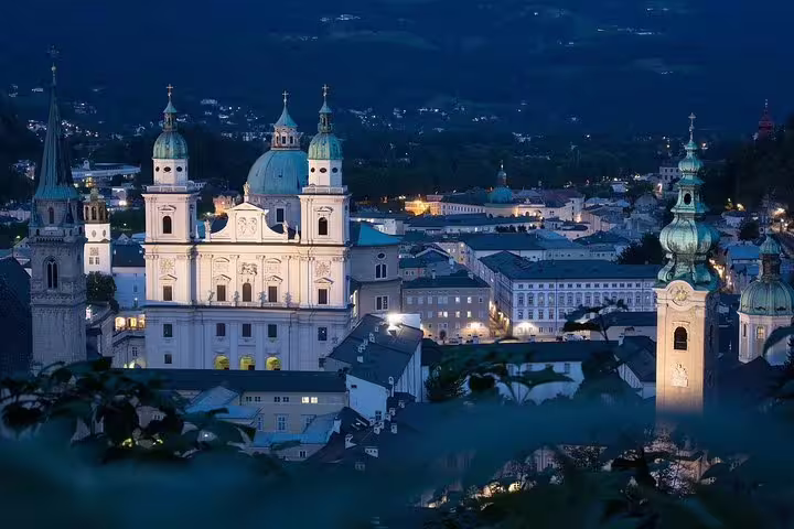 Night view of Salzburg Old Town and Cathedral domes, highlight of a private Salzburg day tour from Vienna