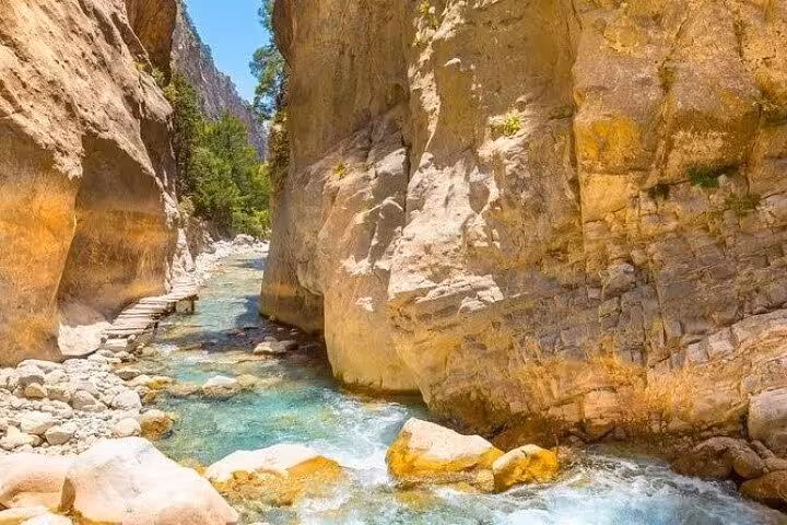 Narrow canyon walls and turquoise river in Samaria Gorge, Crete, full-day trek from Rethymno