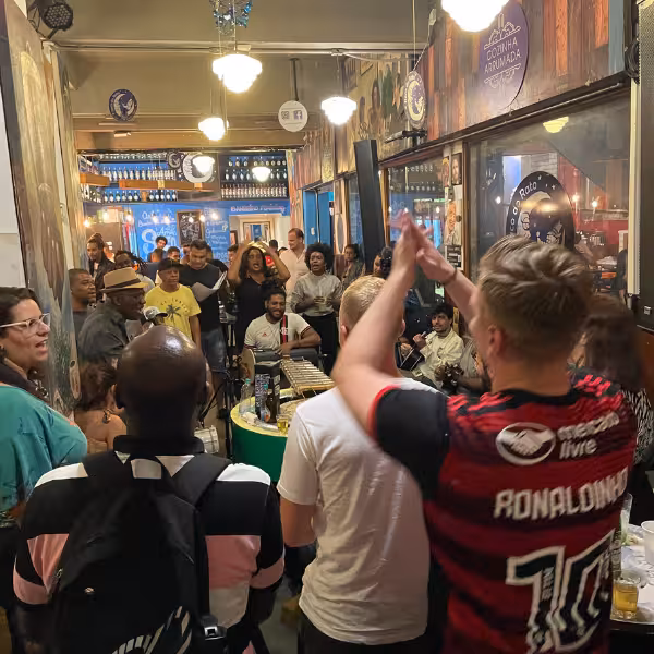 Energetic samba performance in a popular Lapa bar, with guests clapping and joining the lively atmosphere.