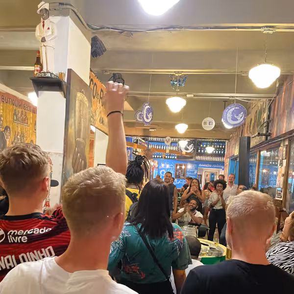 Enthusiastic crowd enjoying live samba music in a bustling Lapa venue for a memorable night experience.