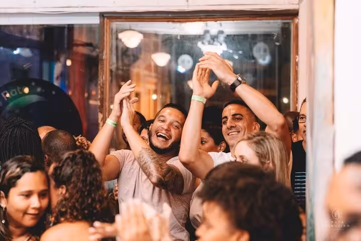Joyful crowd clapping and dancing during vibrant Samba night in Lapa, capturing the lively spirit of Rio's nightlife.