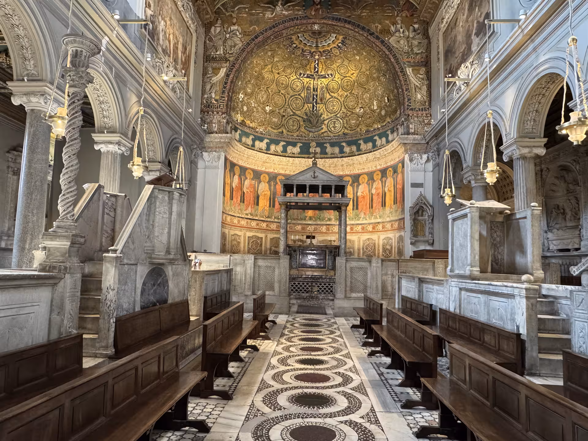 Golden mosaic apse and medieval marble choir of San Clemente Basilica in Rome, visited on underground temples and ruins tour