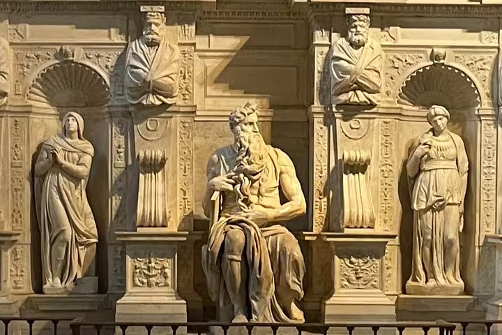 Renaissance marble sculptures and central seated figure inside San Clemente Basilica, a highlight of Rome underground private tours