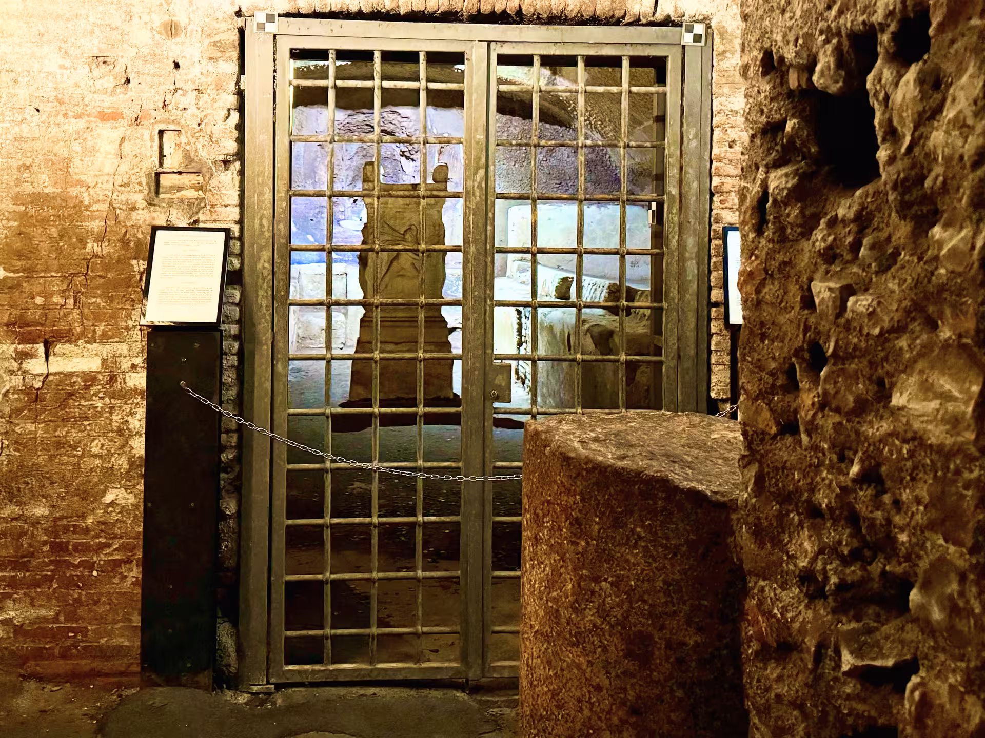 Gated Mithraic temple remains beneath San Clemente Basilica in Rome, explored on an underground ruins and secret basilicas tour