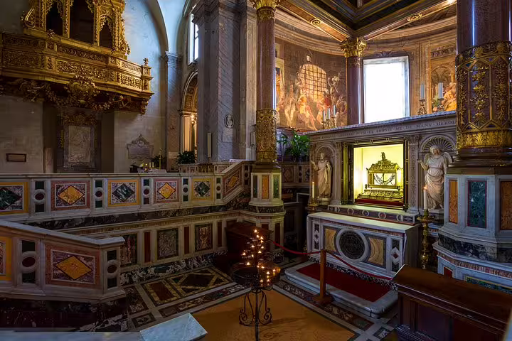 Ornate interior of San Clemente Basilica in Rome with golden altar, relic shrine and frescoes on exclusive private skip-the-line tour