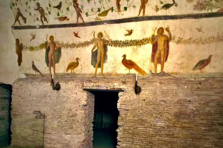 Ancient frescoes and brick walls in the underground levels of San Clemente Basilica explored on a Rome private skip-the-line tour