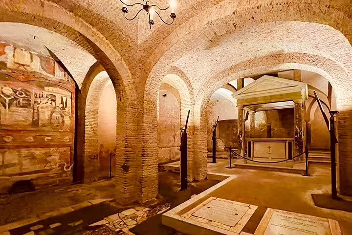 Underground level of Rome’s San Clemente Basilica with ancient arches, frescoes and tombs on a private no-line guided tour