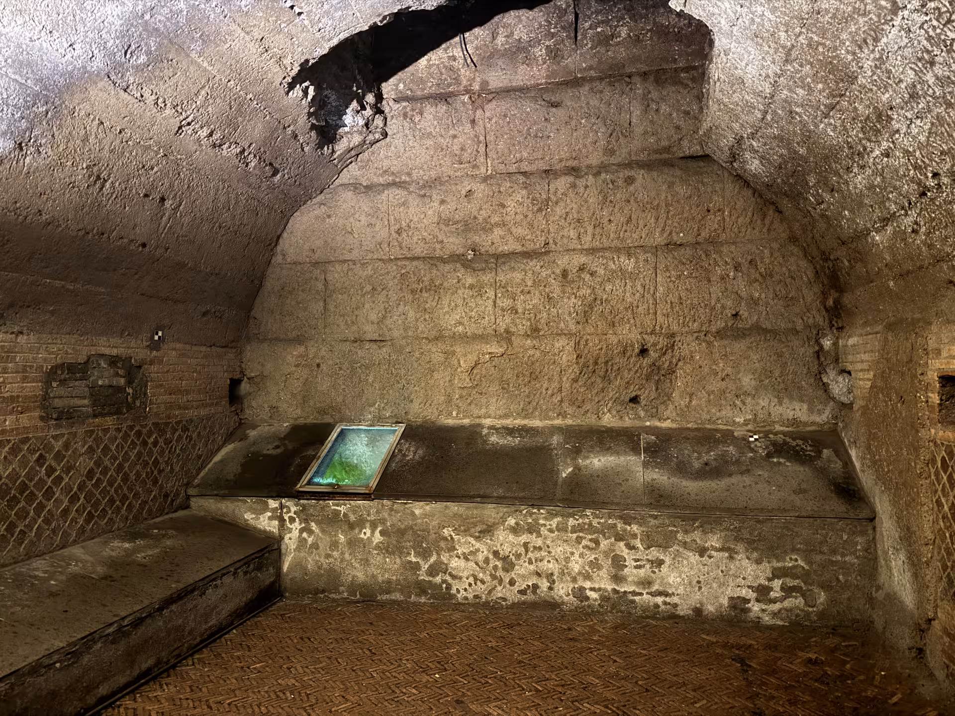 Subterranean vaulted room under San Clemente Basilica in Rome, showcasing early Christian ruins and preserved stone masonry