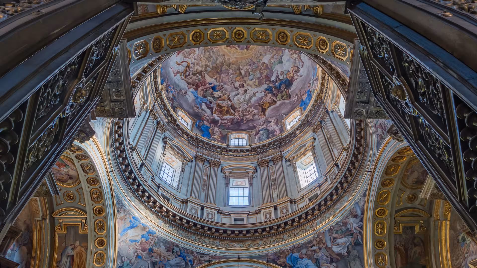 Intricate frescoes and ornate architecture of San Gennaro Chapel's dome in Naples, showcasing artistic grandeur.