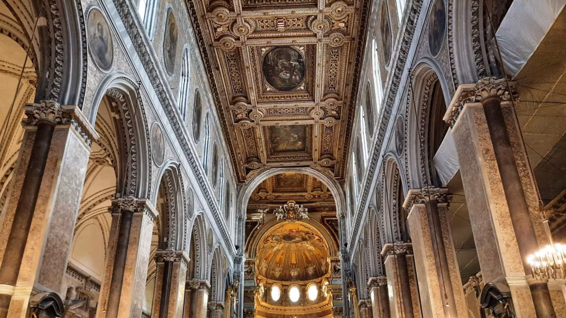 Ornate interior of the San Gennaro Chapel in Naples, featuring intricate arches and detailed ceiling art.