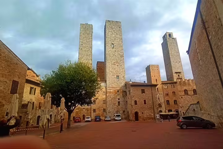 Medieval towers and quiet piazza in San Gimignano, a highlight of the private Volterra and Tuscan wine tasting tour