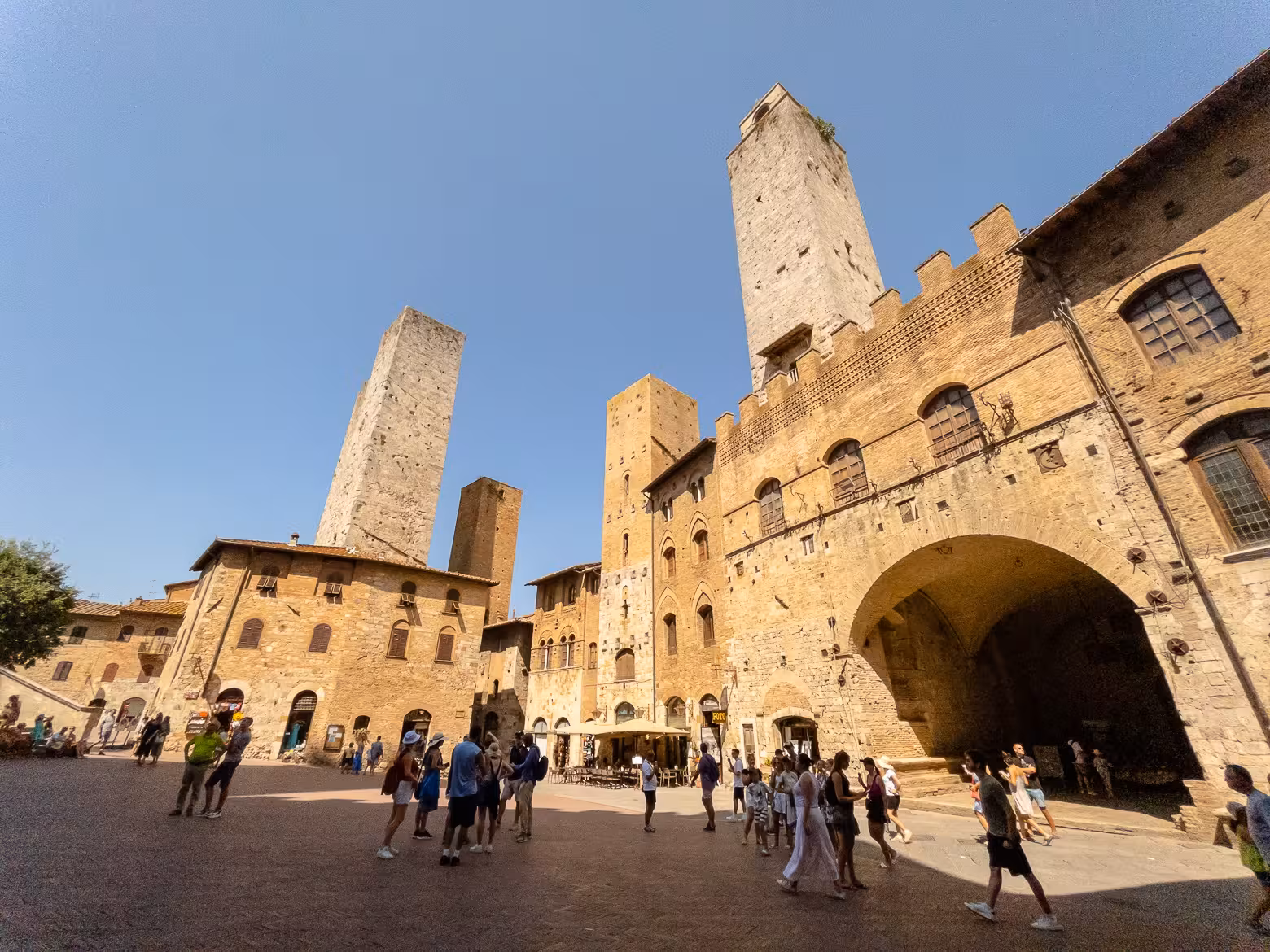 Visitors explore the medieval towers of San Gimignano on the Tuscany Highlights Guided Tour from Florence.