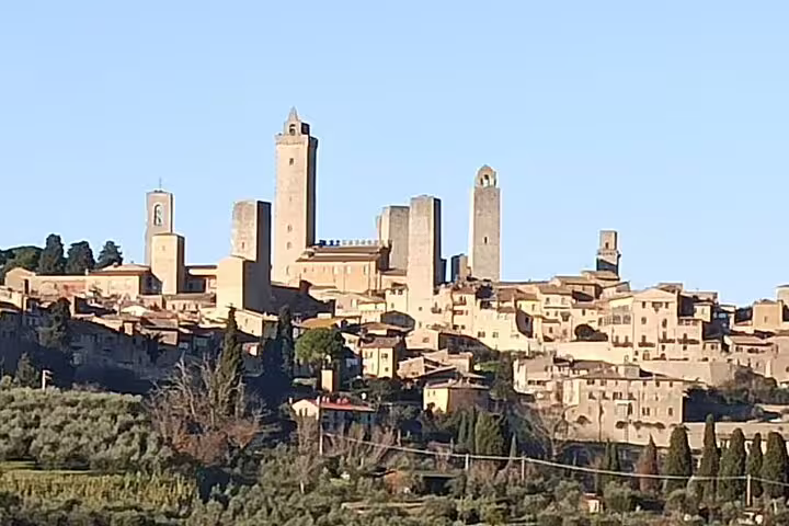 Medieval towers of San Gimignano rising above Tuscan hills, seen on a private shore excursion from Livorno Port with wine tastings