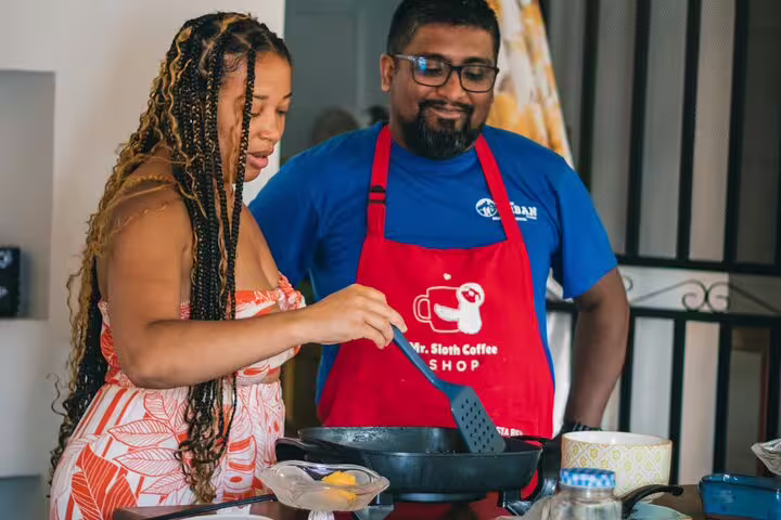 Two people cooking together in a kitchen during the San Jose Bites and Sights Walking Food Tour.
