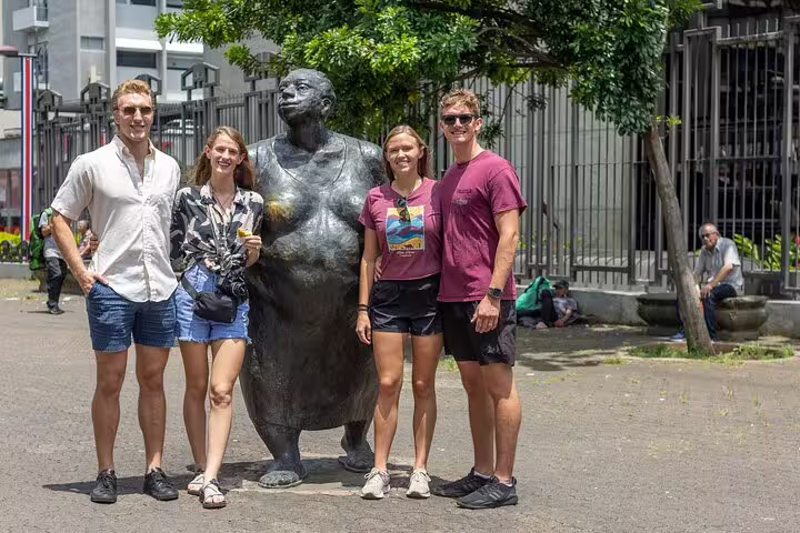 Tourists pose with a whimsical statue in San Jose during the Bites and Sights Walking Food Tour.