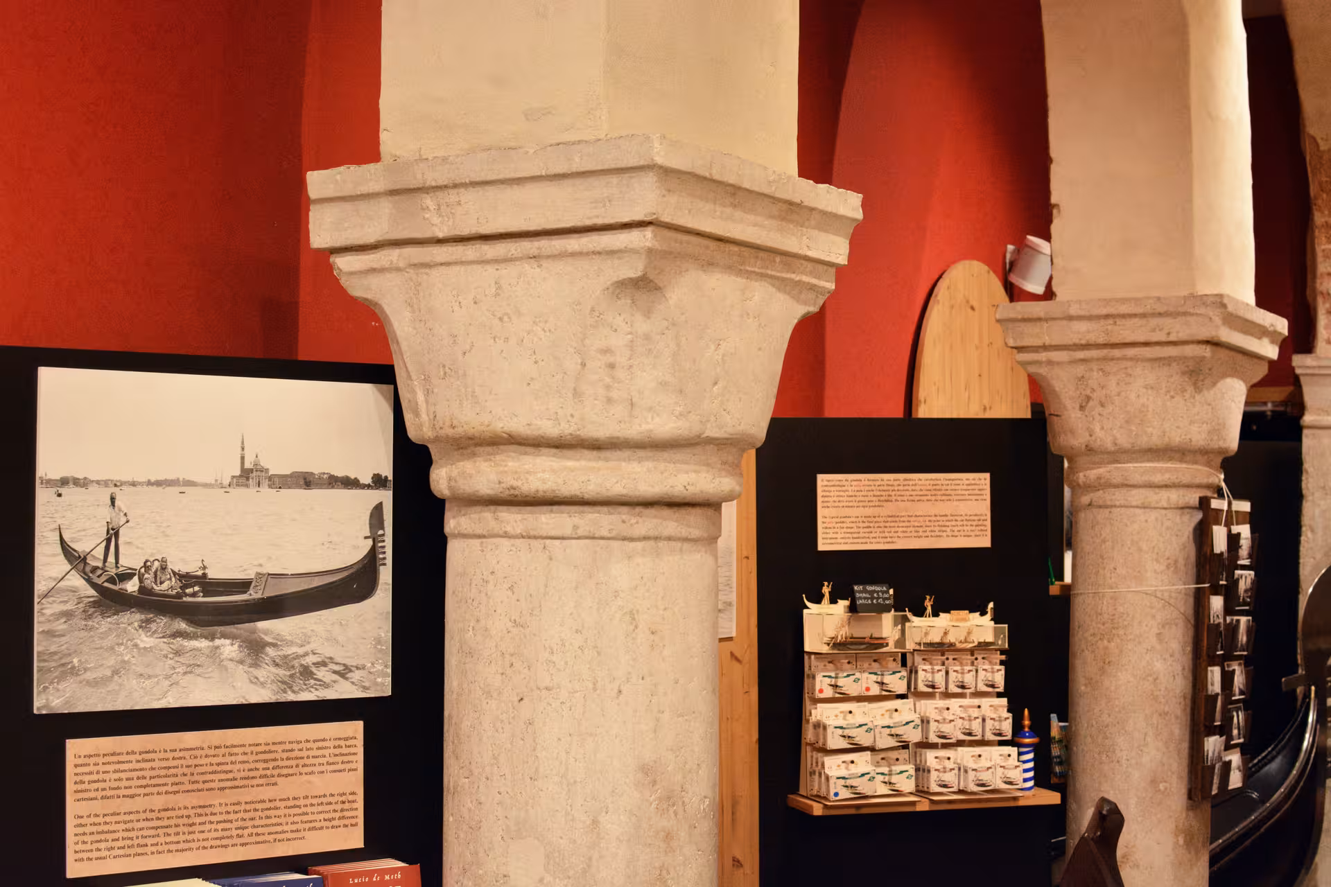 Interior of San Marco History Gallery featuring gondola imagery and Venetian architecture displays.