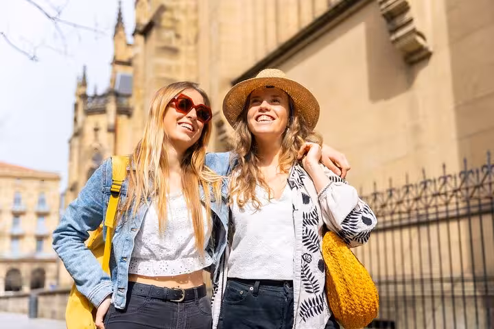 Two women enjoy a sunny day exploring historic San Sebastian on a private two-hour city walk with a local guide.