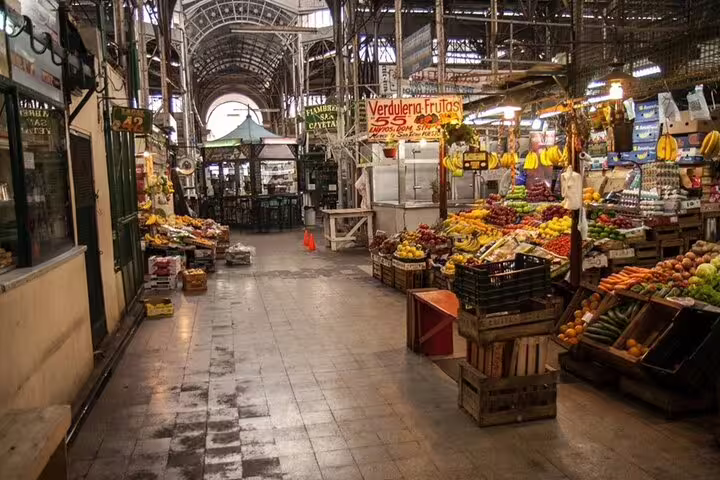 Fruit and vegetable stalls inside San Telmo Market, a classic stop on a Buenos Aires full day sightseeing tour