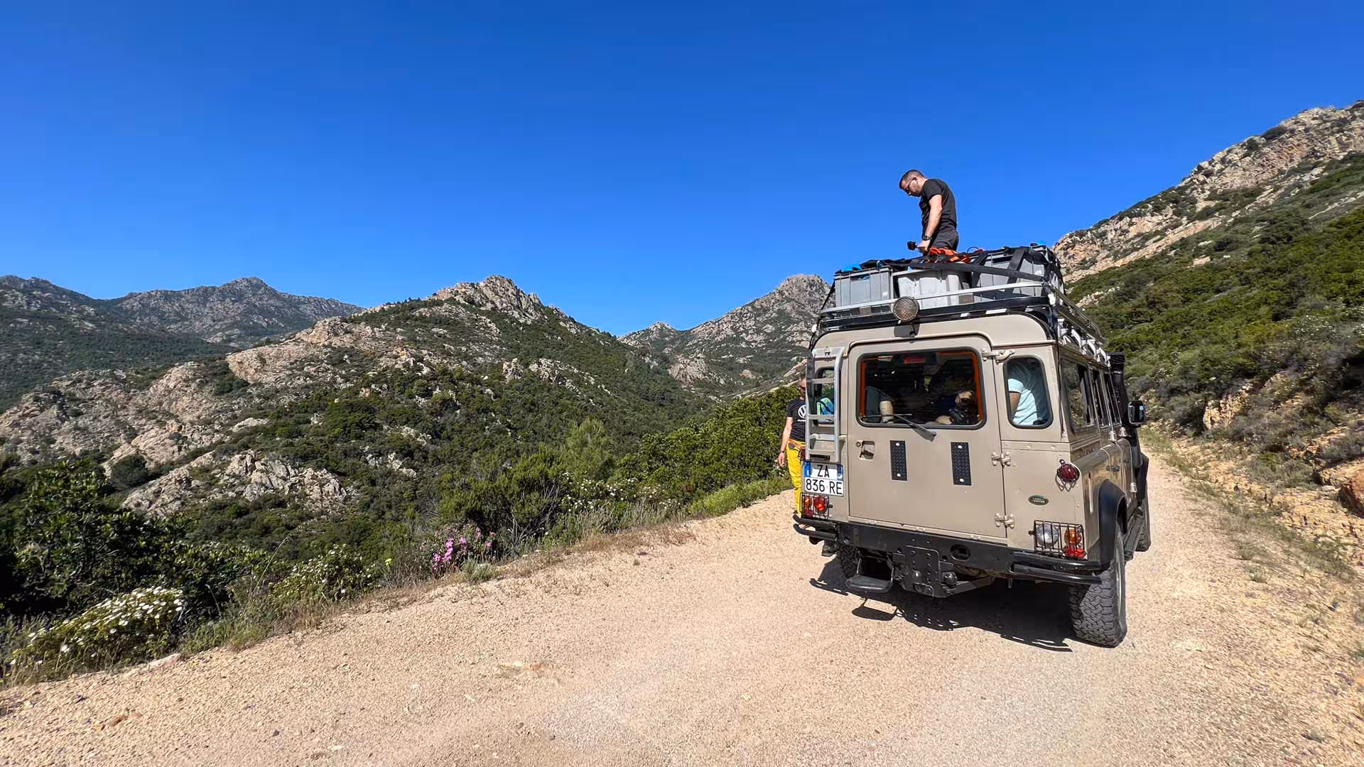 Off-road vehicle parked on rugged terrain during San Teodoro canyoning tour with stunning mountain views.