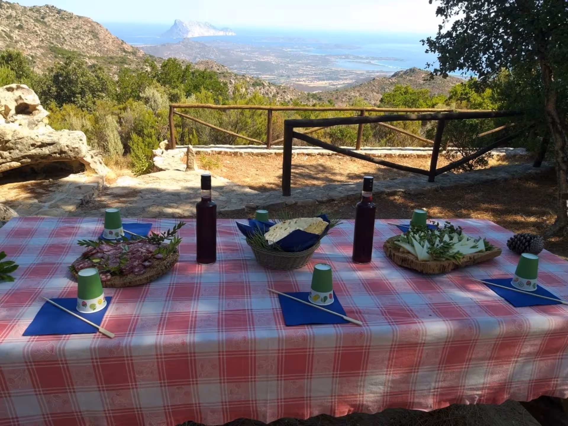 Scenic picnic setup overlooking stunning Rio Pitrisconi views on the San Teodoro jeep tour, featuring local delicacies.