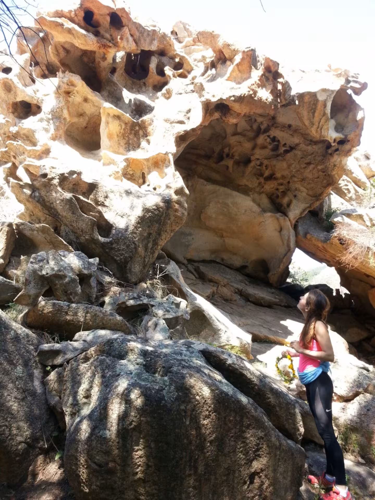 Woman admires unique rock formations on an adventurous trek to Rio Pitrisconi from San Teodoro.