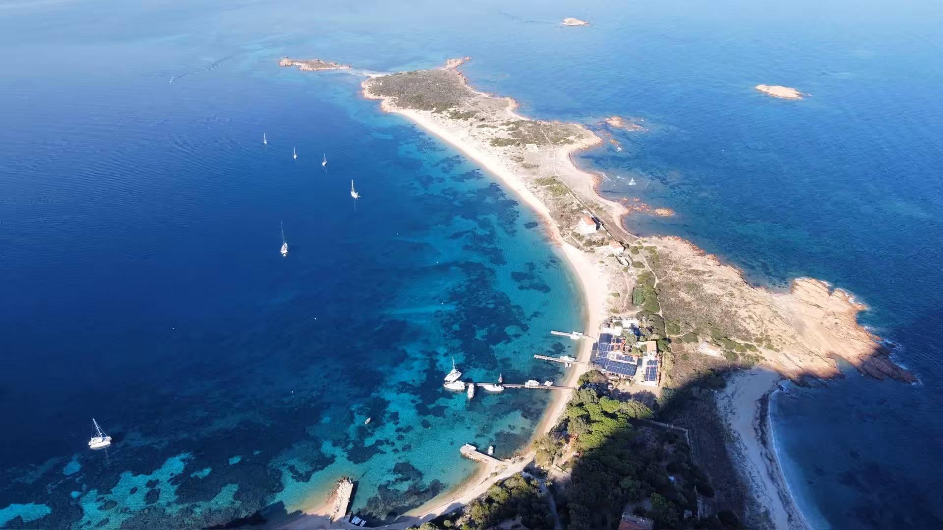 Aerial view of San Teodoro coastline with sailing boats and turquoise waters, perfect for a scenic boat tour.