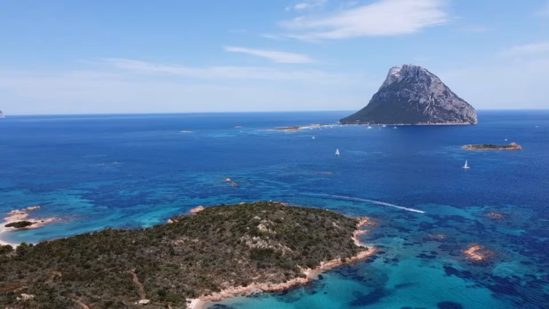 Panoramic view of islands and turquoise sea near San Teodoro, ideal for a scenic sailing boat tour.