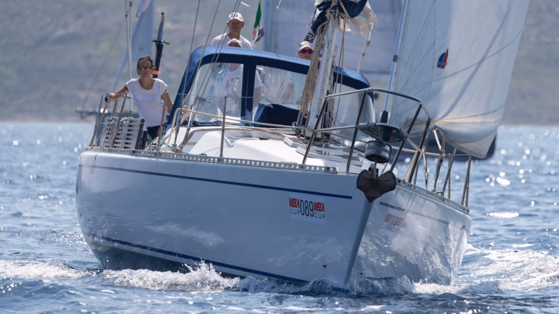 Sailing boat gliding through clear waters off San Teodoro, perfect for a scenic Sardinia sailing tour.
